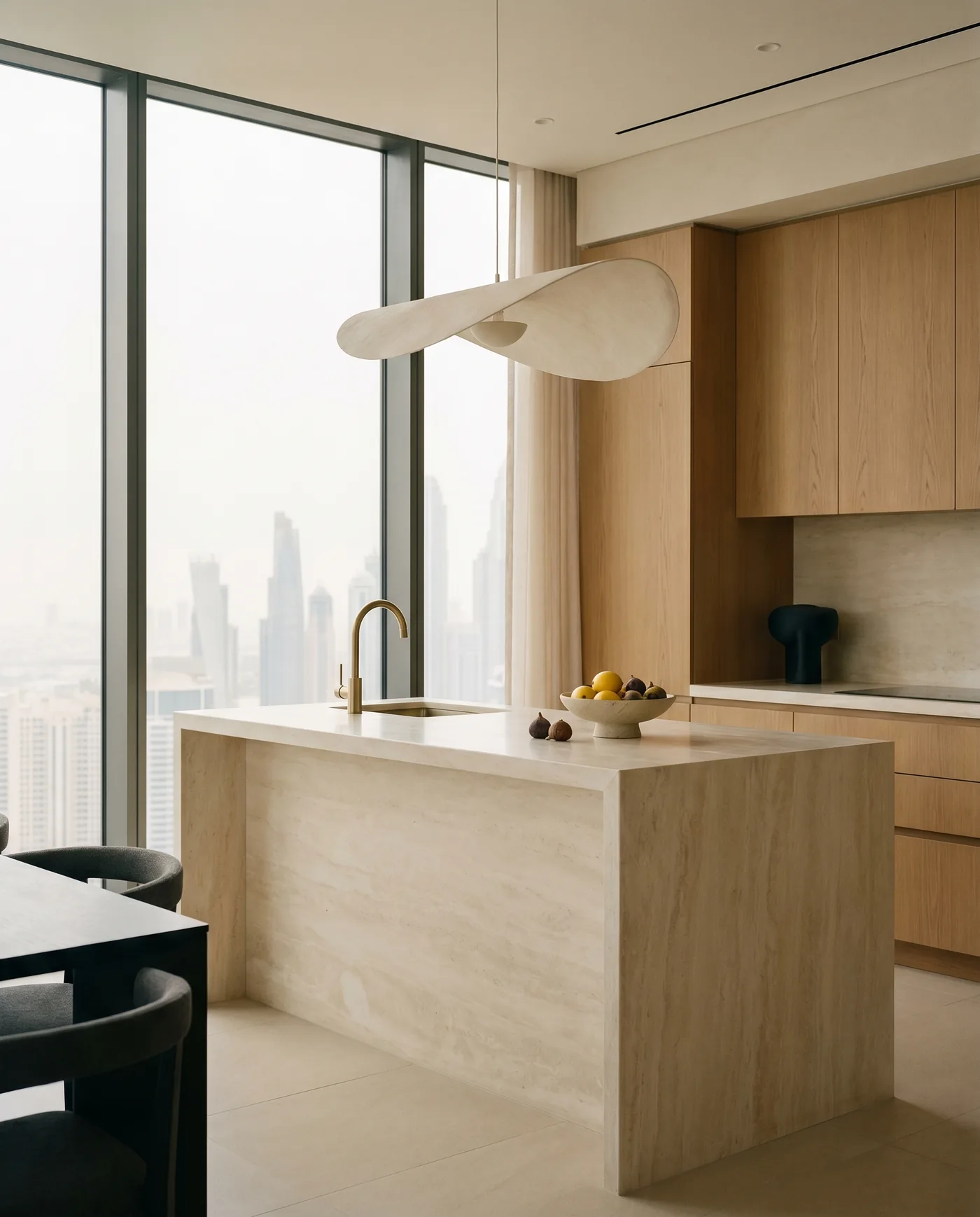 Travertine waterfall kitchen island with oak cabinetry, Dubai